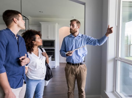 A real estate agent showing a home to their buyer client 